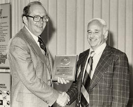 Lou Zimmerman, Jewish Community Council, and Dick Kavanagh holding a United Way plaque