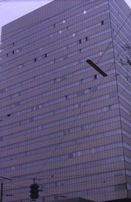 High-rise building and a street light in the lower left hand corner of the image