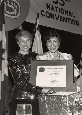 A Job Well Done. Judy Mandleman receives a plaque from Sandy Chernoff